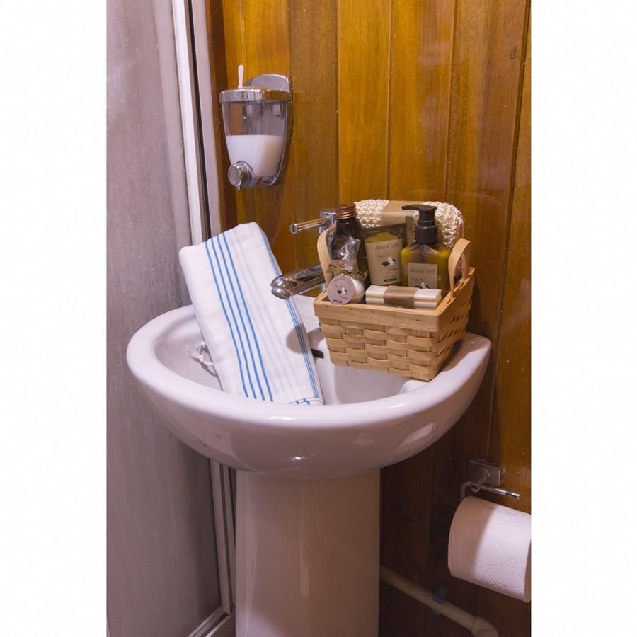 a sink with a basket on it aboard NEMESIS Yacht for Sale