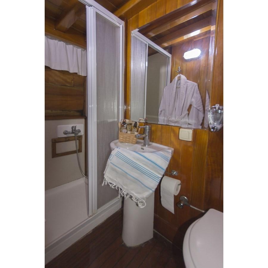 a bathroom with a toilet and a sink aboard NEMESIS Yacht for Sale