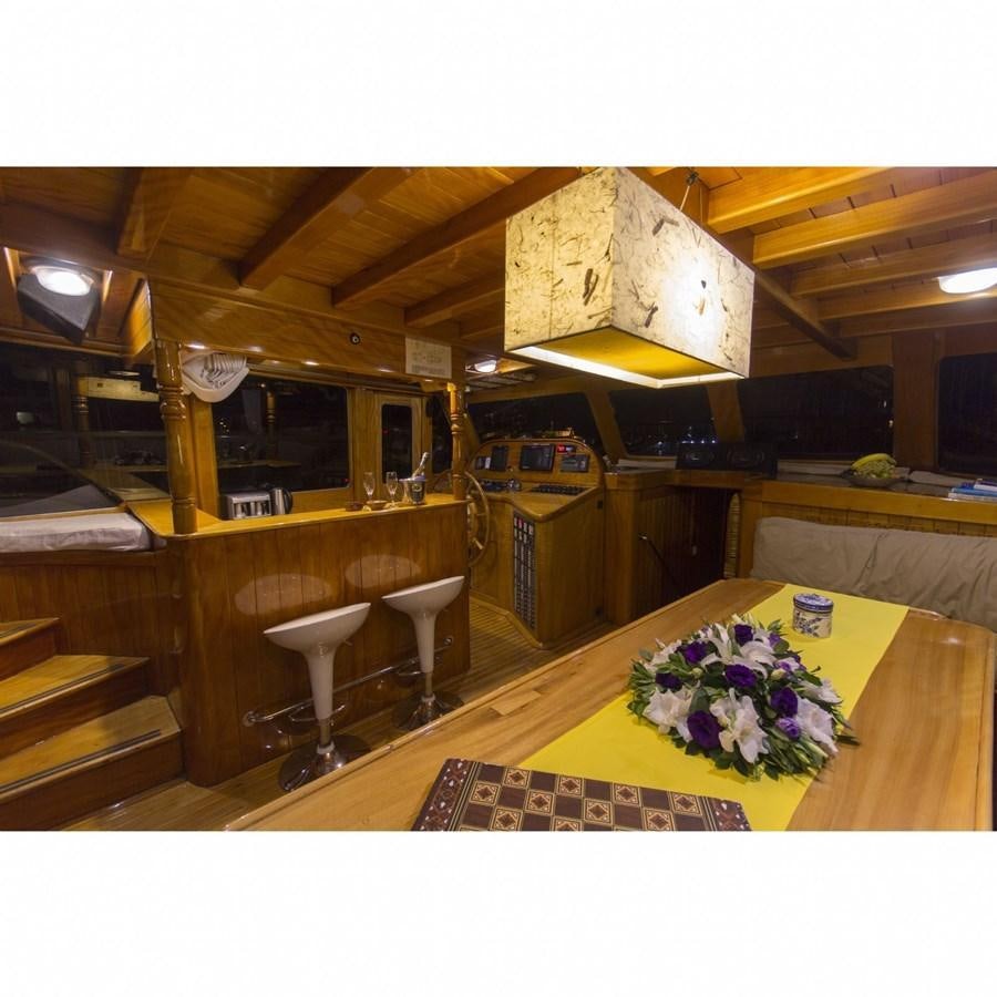 a room with a table and chairs aboard NEMESIS Yacht for Sale