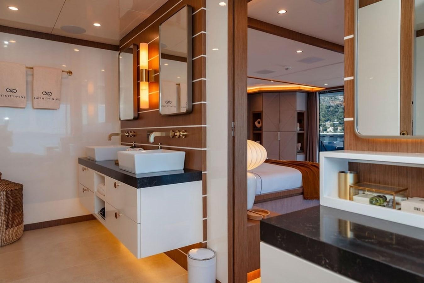 a bathroom with a sink and a bed aboard INFINITY NINE Yacht for Sale