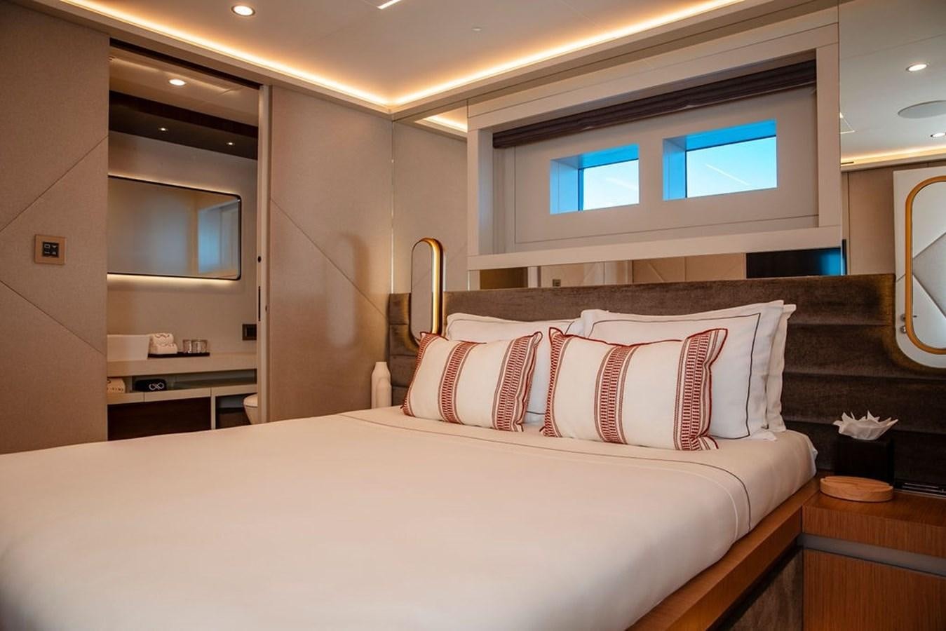 a bed with a white bed spread aboard INFINITY NINE Yacht for Sale