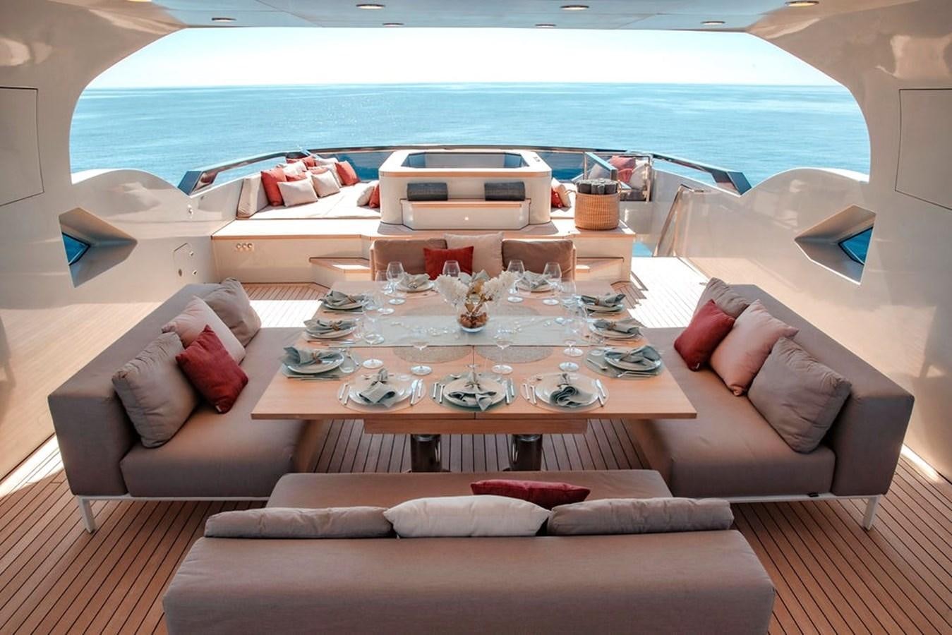 a living room with a large sofa and a large blue ocean aboard INFINITY NINE Yacht for Sale