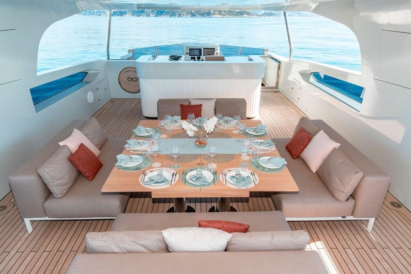 a room with a table and couches aboard INFINITY NINE Yacht for Sale