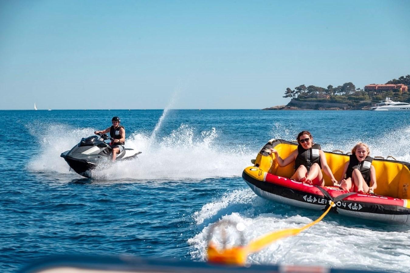 a group of people on a jet ski in the water aboard INFINITY NINE Yacht for Sale