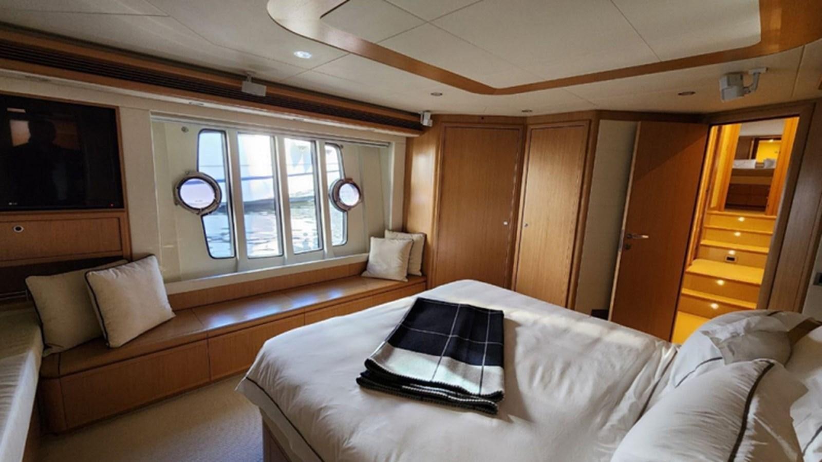 a room with a bed and a television aboard FERRETTI 870 Yacht for Sale