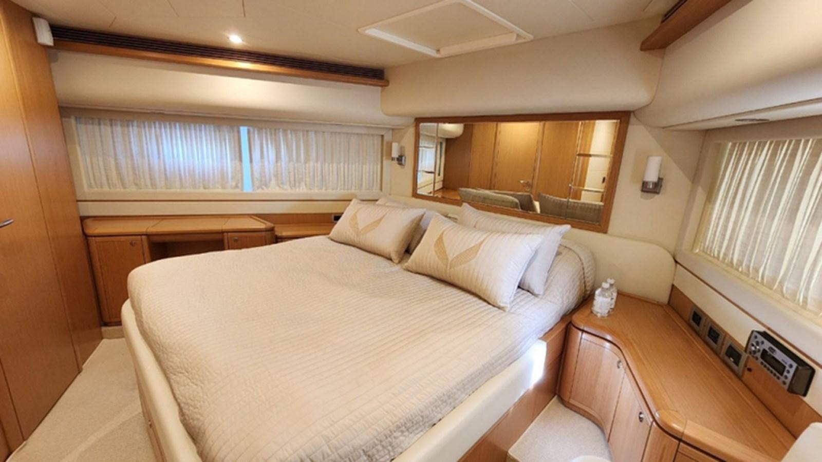 a bedroom with a bed and desk aboard FERRETTI 870 Yacht for Sale