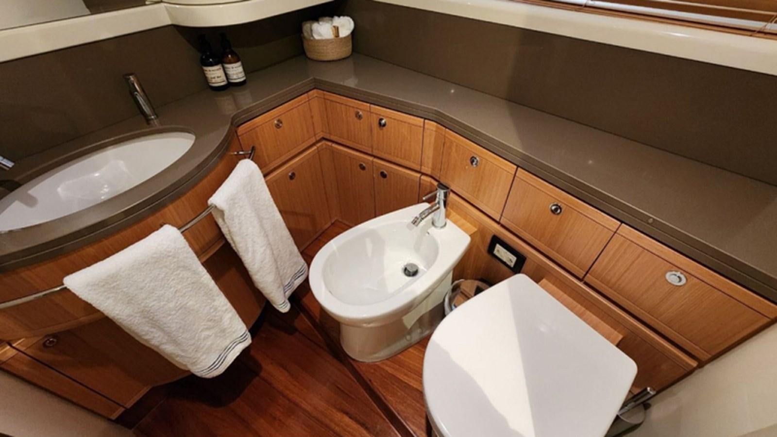 a bathroom with wooden cabinets aboard FERRETTI 870 Yacht for Sale