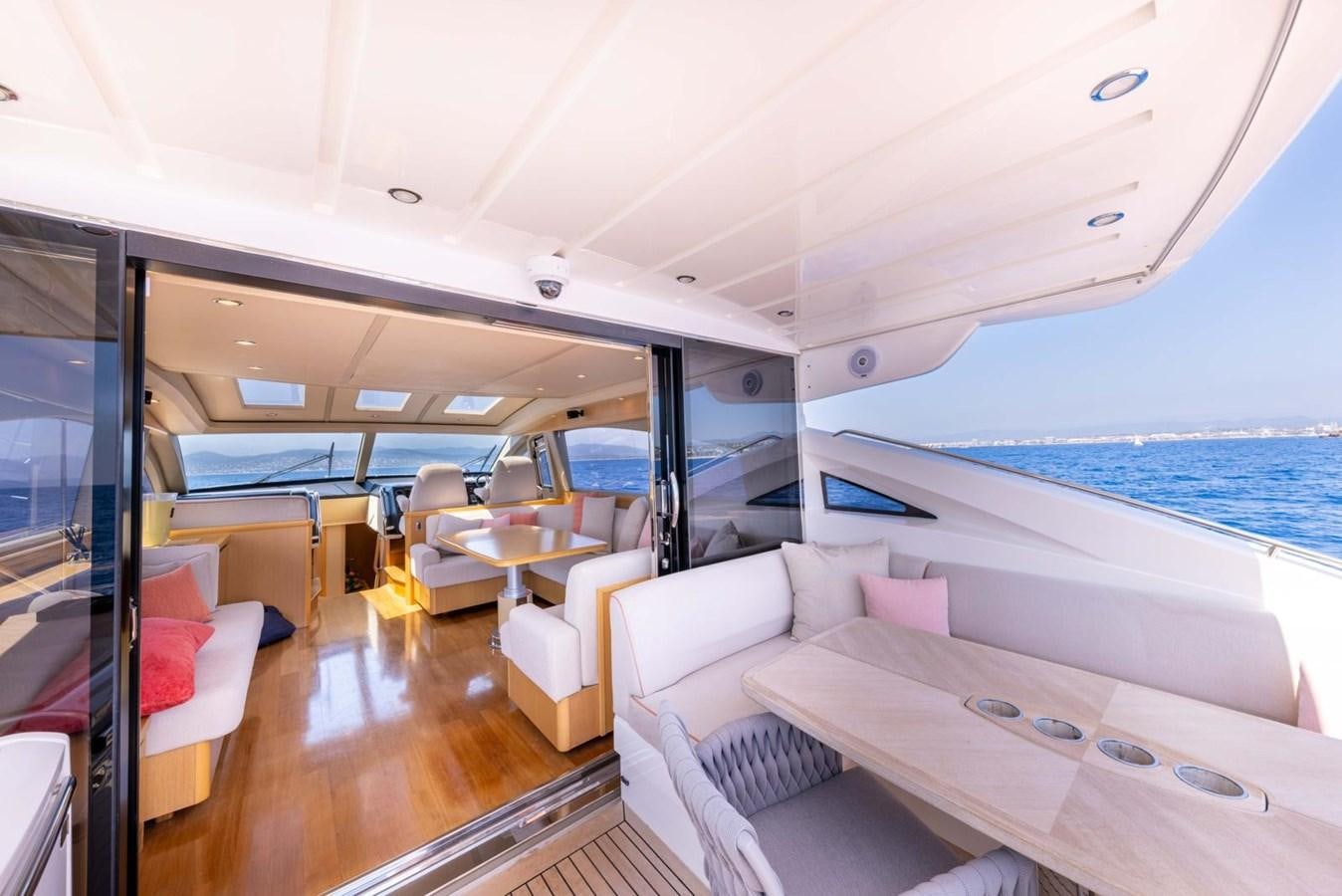 a boat with a table and chairs aboard PRINCESS V70 Yacht for Sale