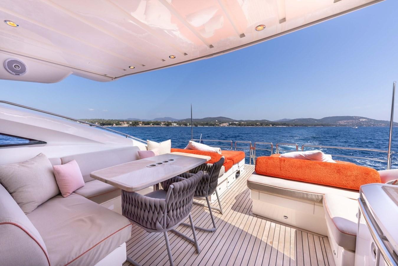 a deck with a view of the ocean and a beach aboard PRINCESS V70 Yacht for Sale