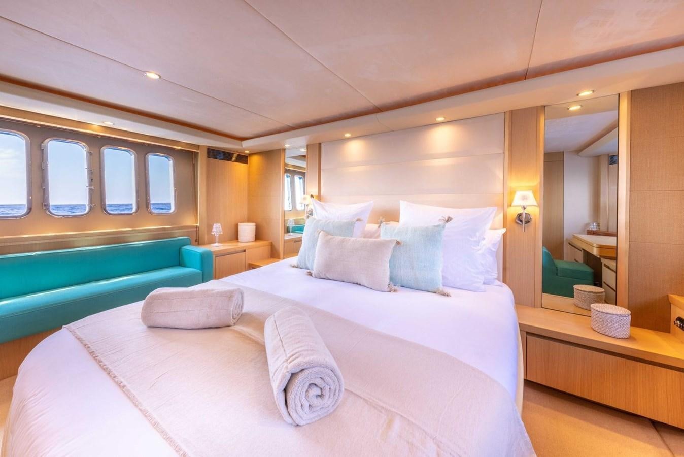 a bed with a white comforter aboard PRINCESS V70 Yacht for Sale