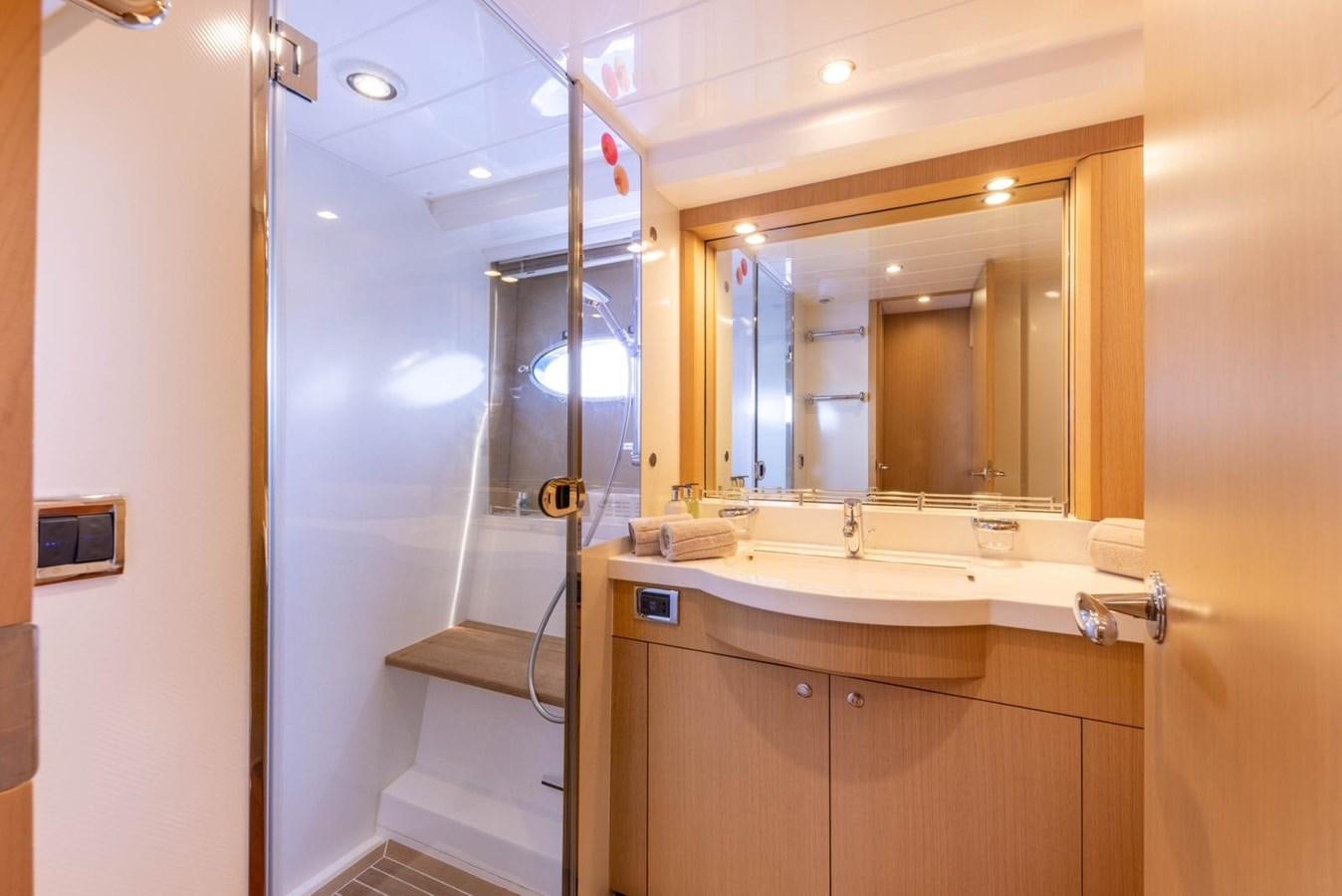 a bathroom with a large mirror aboard PRINCESS V70 Yacht for Sale