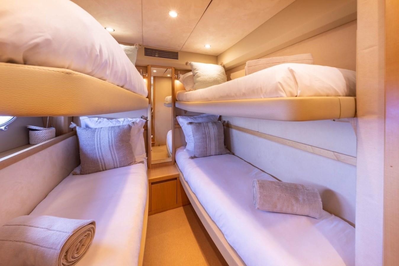 a room with beds and a bed aboard PRINCESS V70 Yacht for Sale