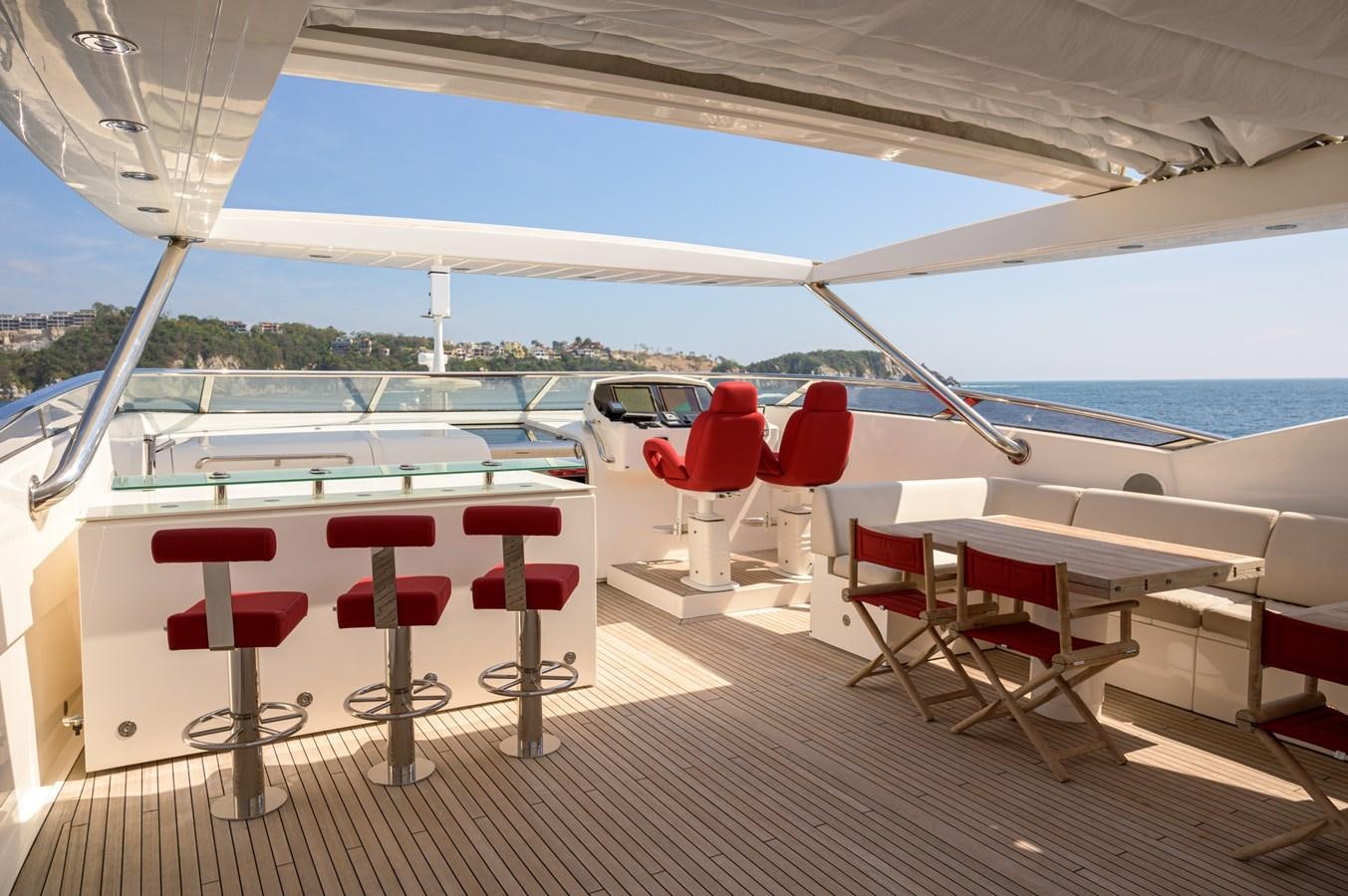 a boat with red chairs aboard M5 Yacht for Sale