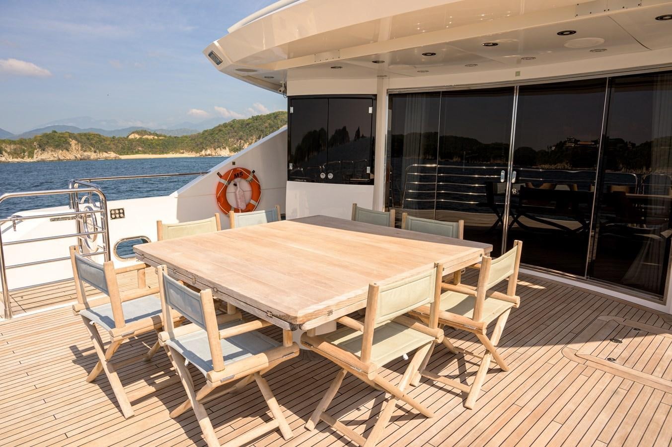 a table on a deck aboard M5 Yacht for Sale