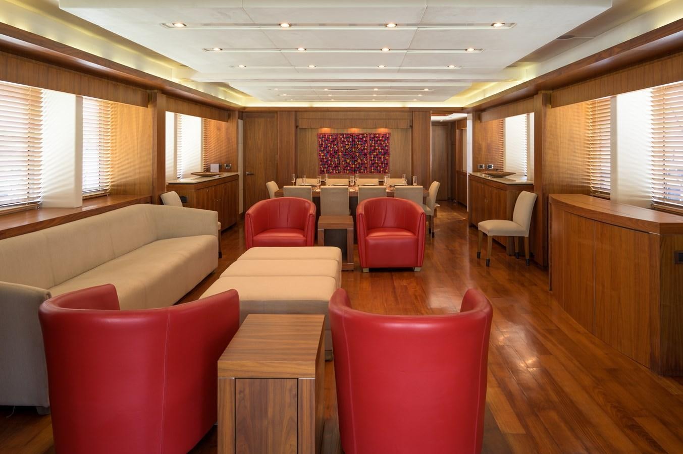 a room with tables and chairs aboard M5 Yacht for Sale