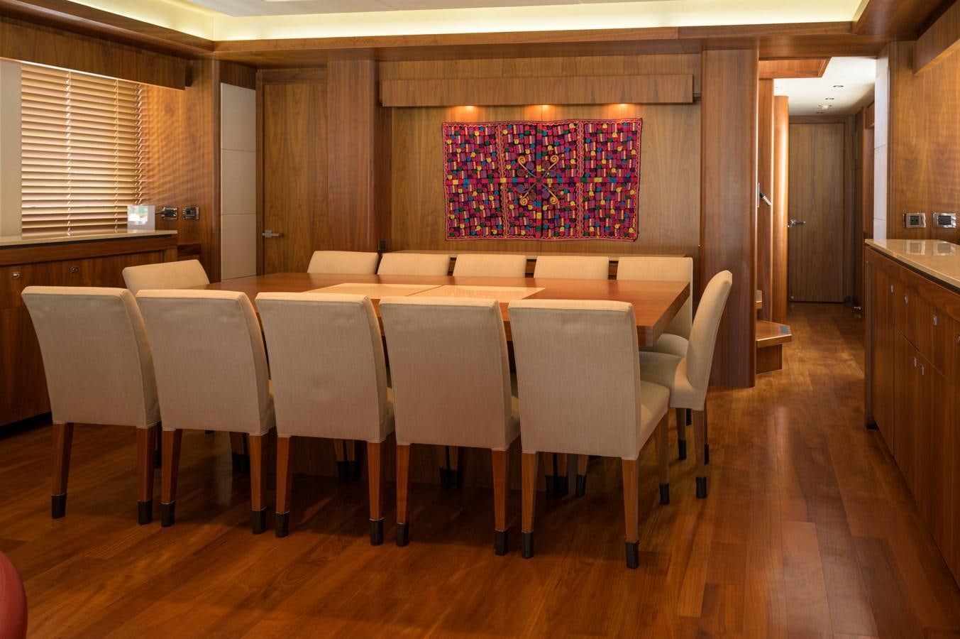 a room with a table and chairs aboard M5 Yacht for Sale