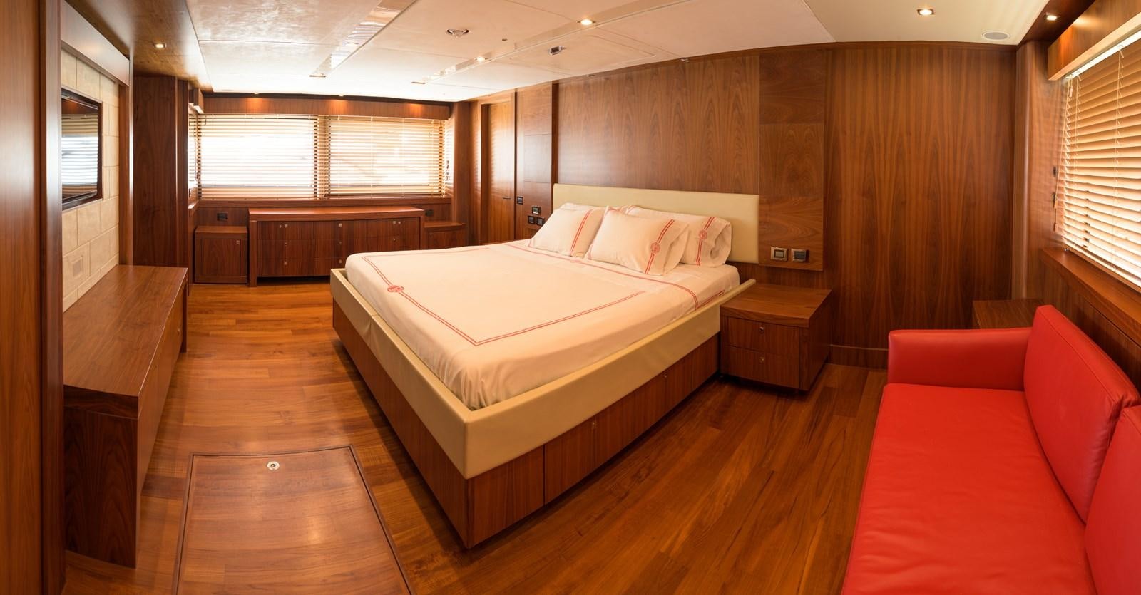 a large bedroom with a bed aboard M5 Yacht for Sale