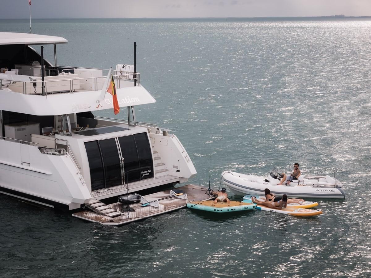 a boat with a boat on it aboard JUST A VACATION Yacht for Sale