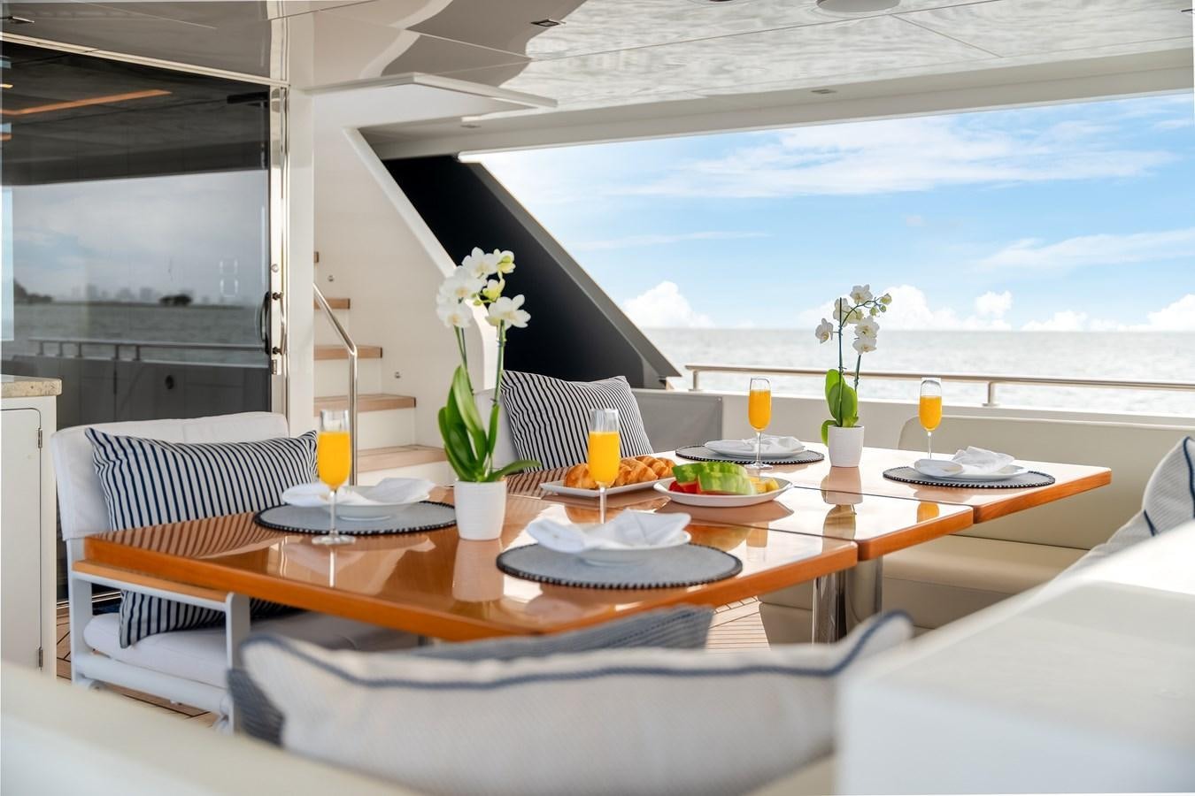 a table with food and drinks on it aboard JUST A VACATION Yacht for Sale