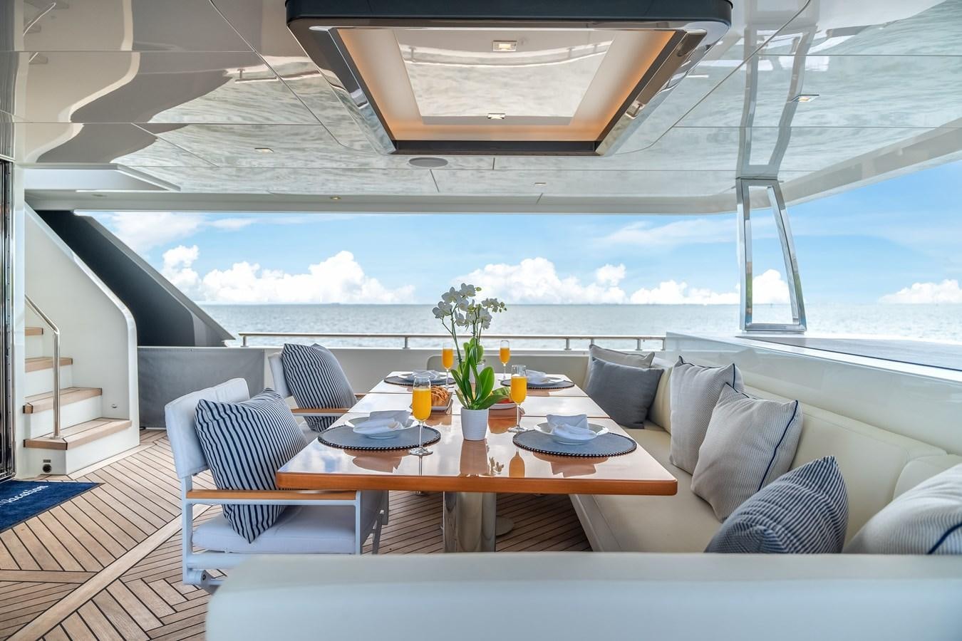 a large open living room with a large balcony aboard JUST A VACATION Yacht for Sale
