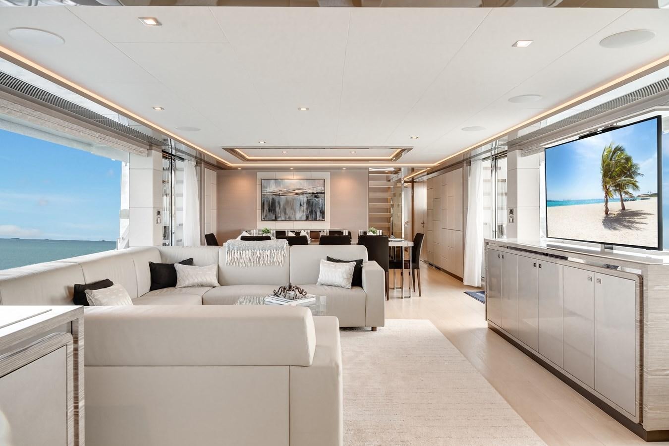 a living room with a large window aboard JUST A VACATION Yacht for Sale