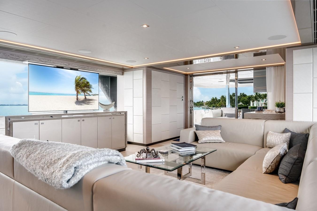 a living room with a large window aboard JUST A VACATION Yacht for Sale