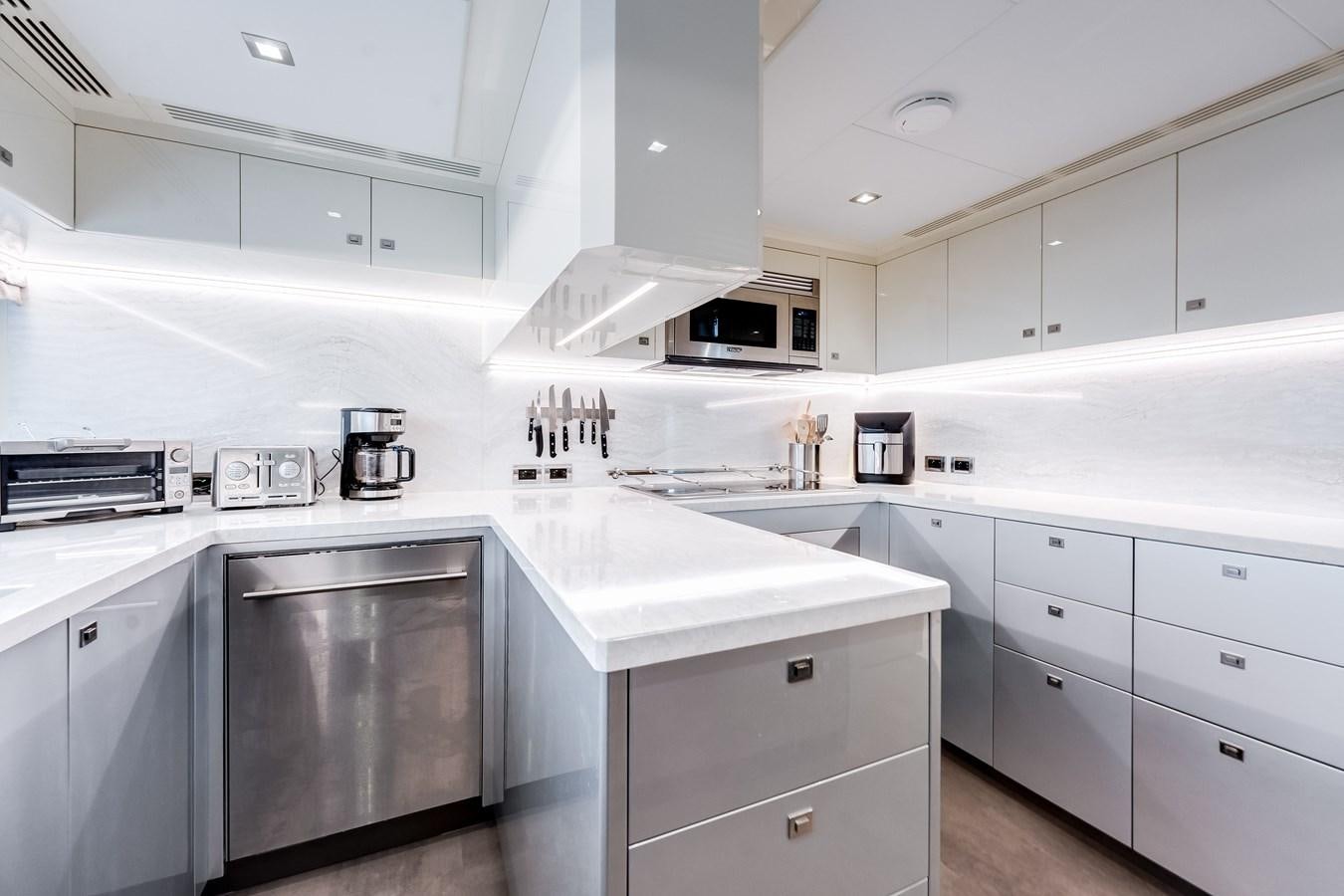 a kitchen with white cabinets aboard JUST A VACATION Yacht for Sale
