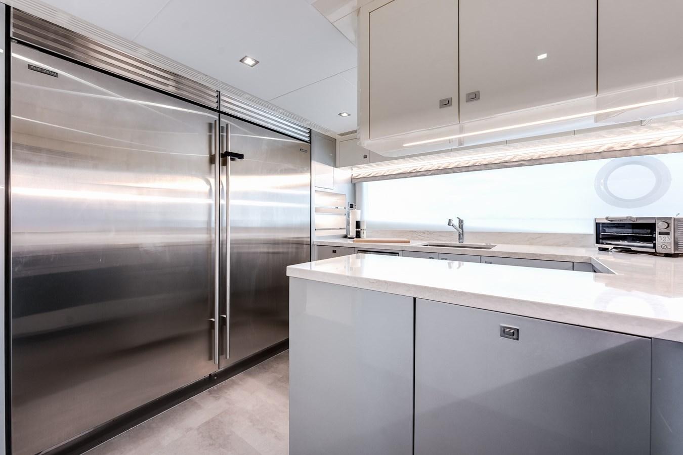 a kitchen with white cabinets aboard JUST A VACATION Yacht for Sale