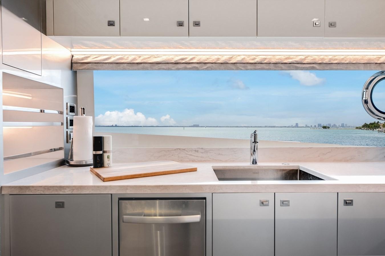 a kitchen with white cabinets aboard JUST A VACATION Yacht for Sale