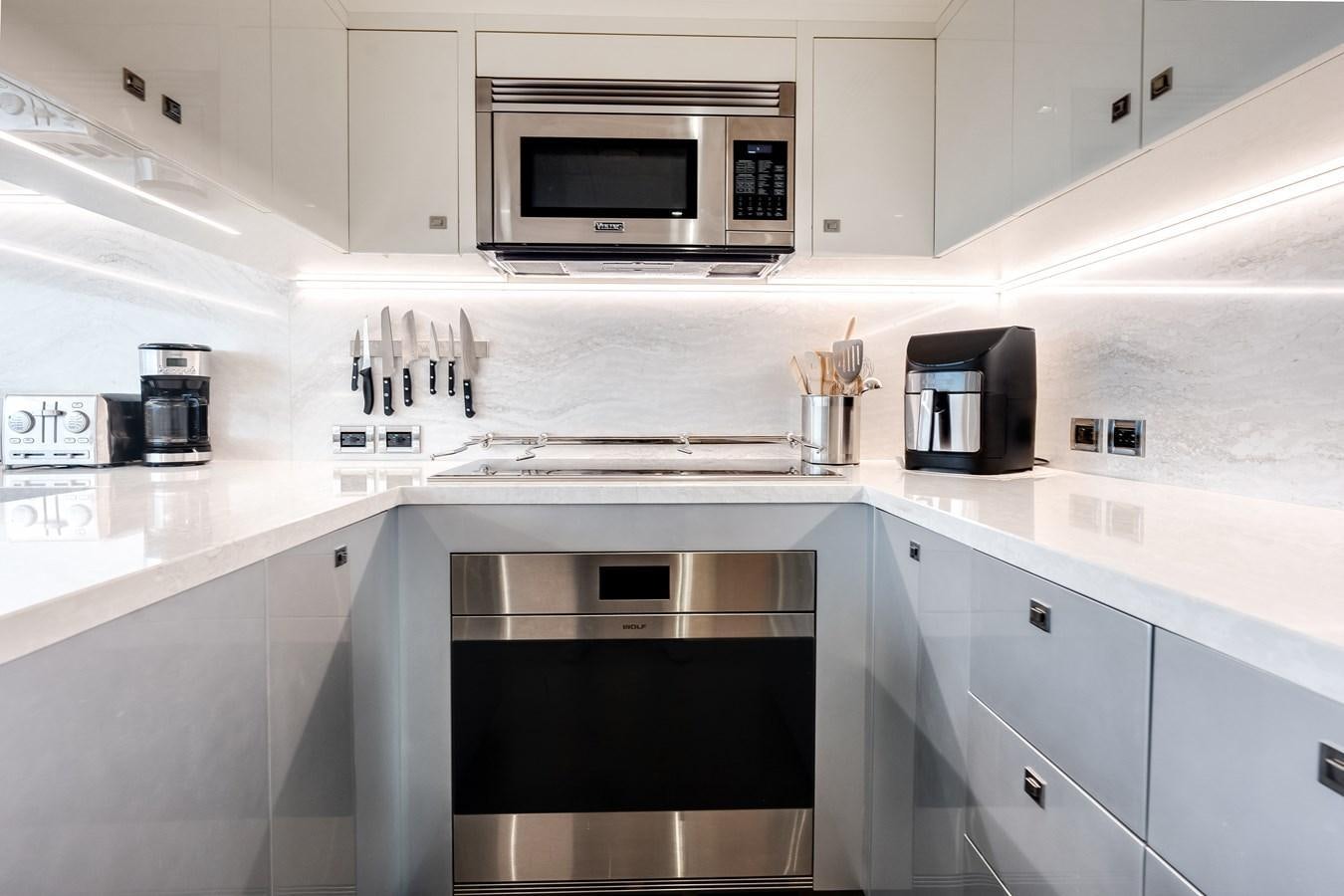 a kitchen with white cabinets aboard JUST A VACATION Yacht for Sale