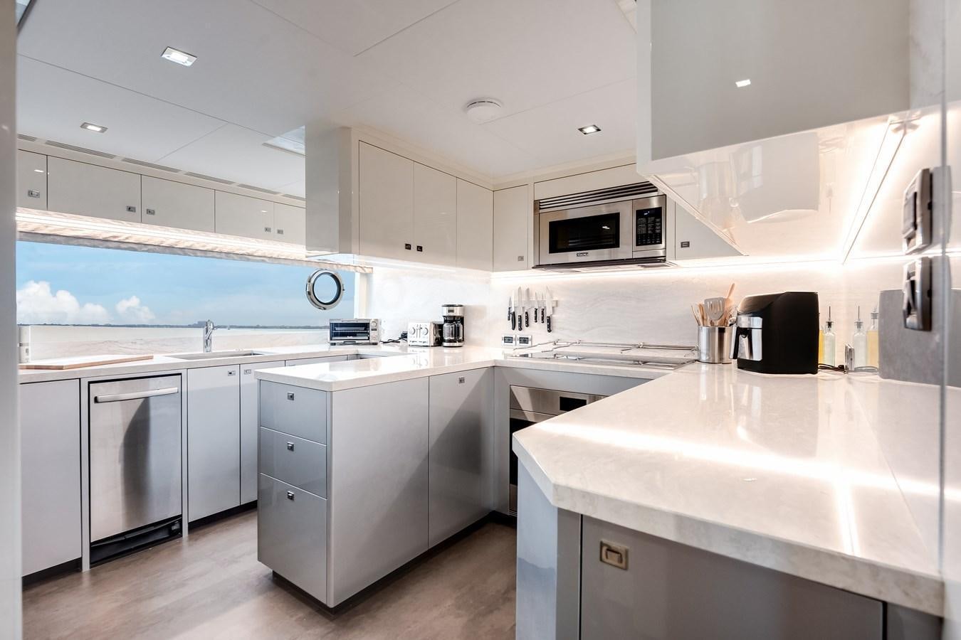 a kitchen with white cabinets aboard JUST A VACATION Yacht for Sale