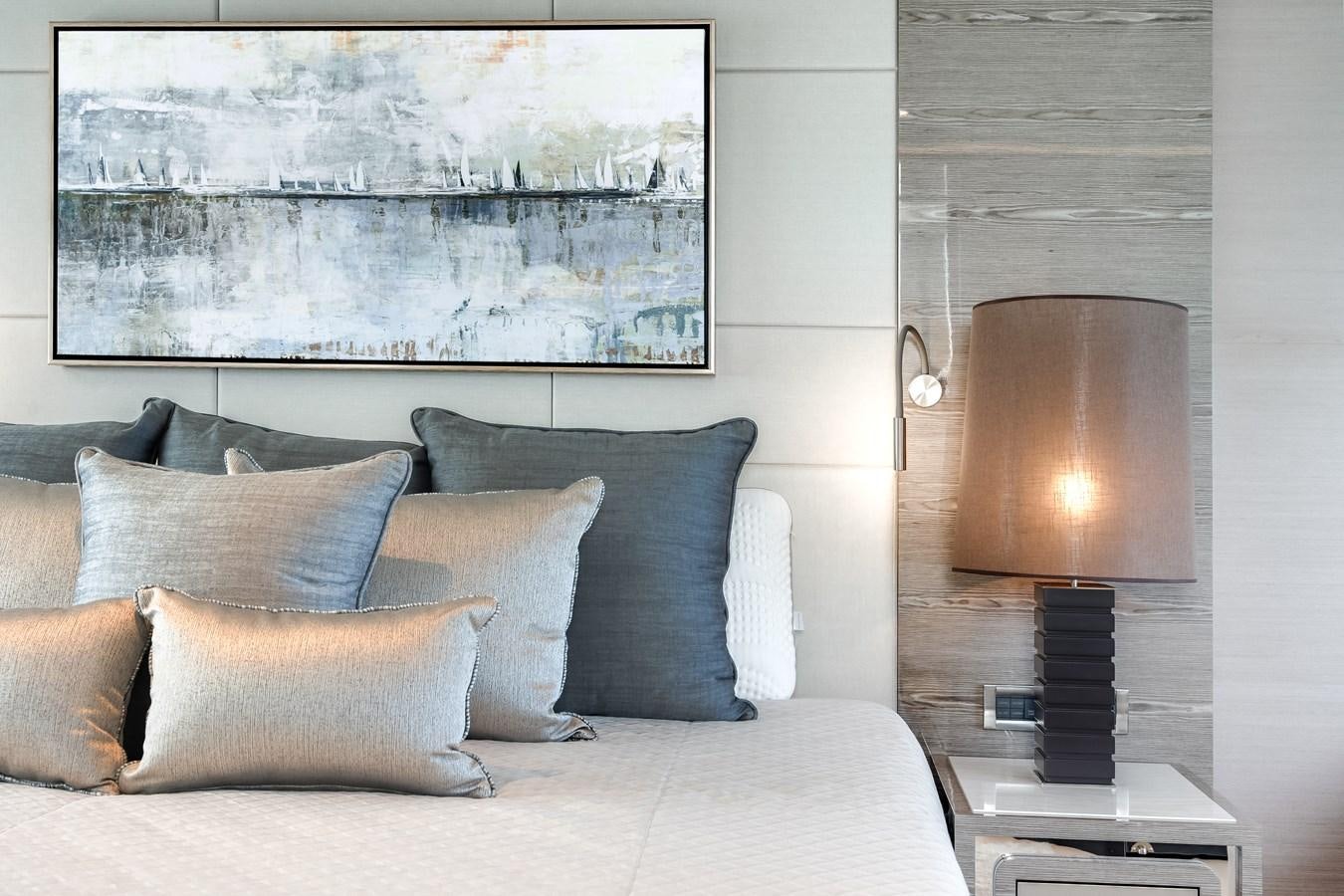 a bed with pillows and a lamp aboard JUST A VACATION Yacht for Sale