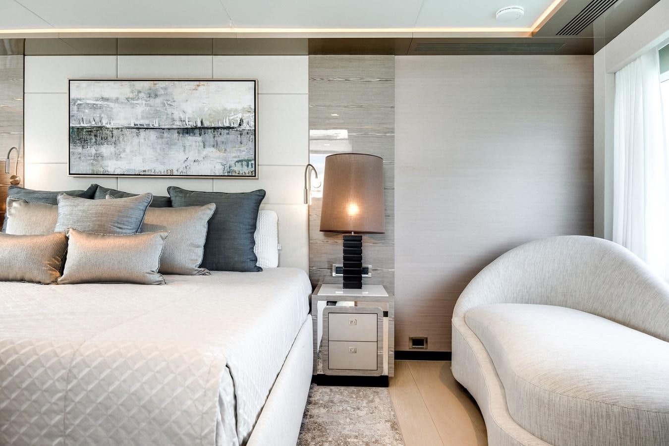 a bedroom with a bed and a lamp aboard JUST A VACATION Yacht for Sale