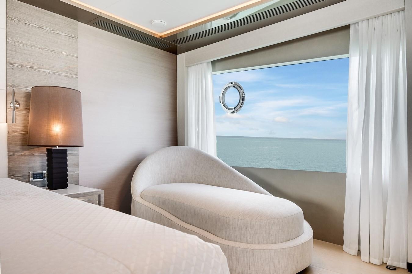 a room with a bed and a lamp aboard JUST A VACATION Yacht for Sale