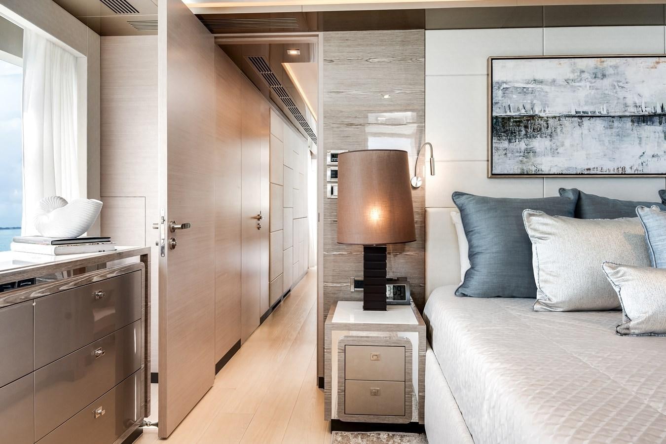 a bedroom with a bed and a desk aboard JUST A VACATION Yacht for Sale