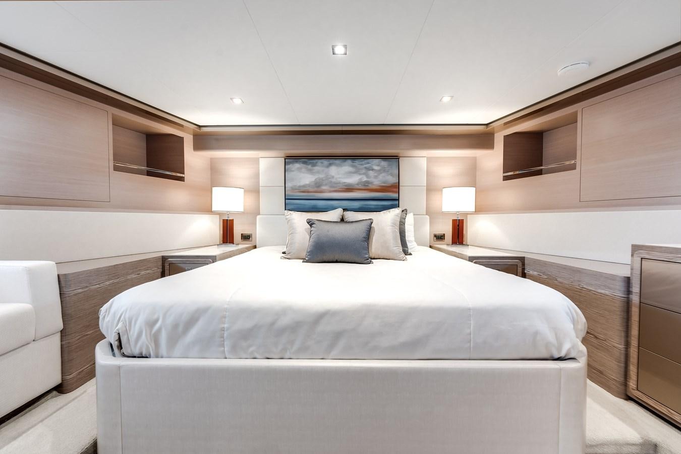 a room with a bed and a lamp aboard JUST A VACATION Yacht for Sale