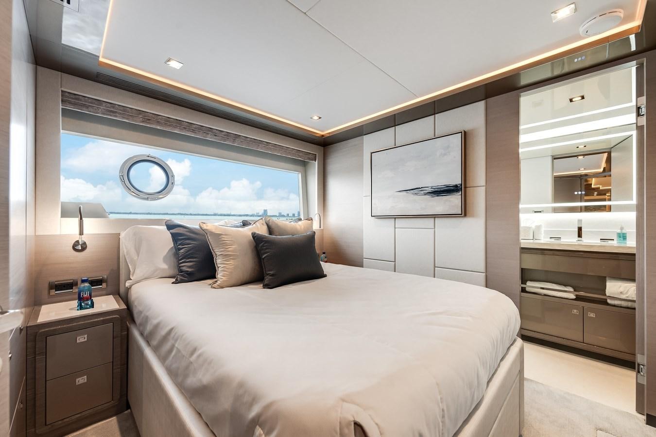 a bedroom with a bed and a mirror aboard JUST A VACATION Yacht for Sale