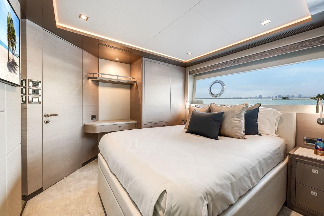 a bedroom with a bed and a desk aboard JUST A VACATION Yacht for Sale