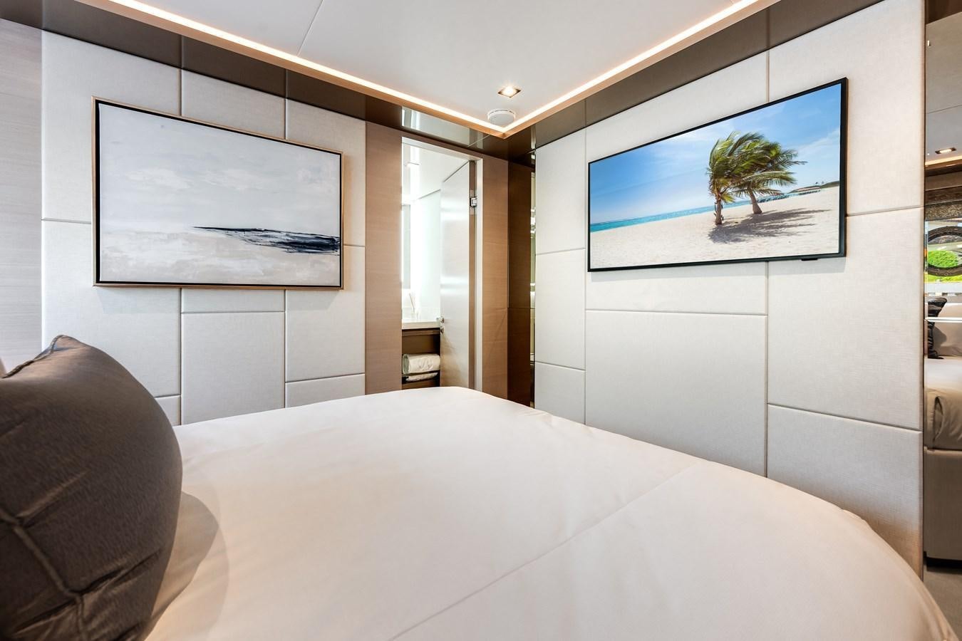 a bed with a white sheet and a picture on the wall aboard JUST A VACATION Yacht for Sale