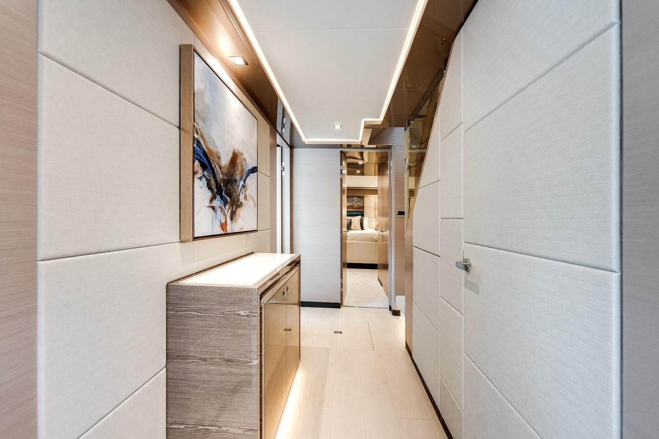 a hallway with paintings on the wall aboard JUST A VACATION Yacht for Sale