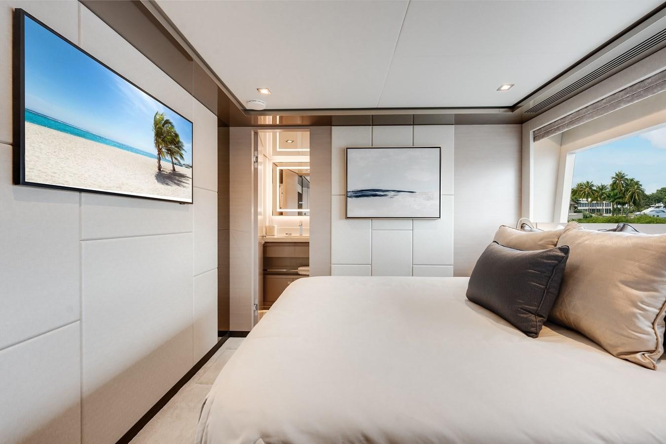 a bedroom with a bed and a painting on the wall aboard JUST A VACATION Yacht for Sale