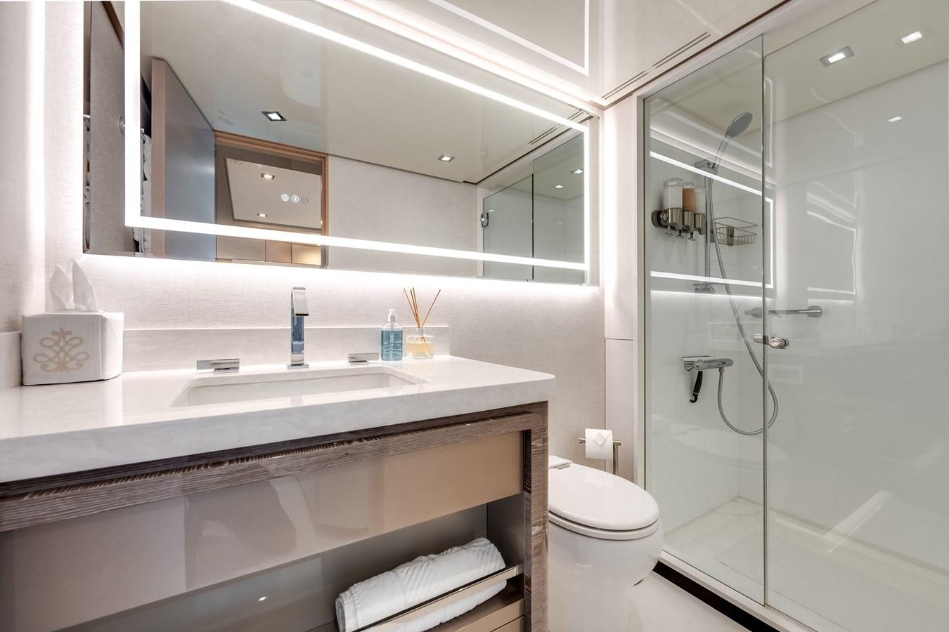a bathroom with a glass shower door aboard JUST A VACATION Yacht for Sale