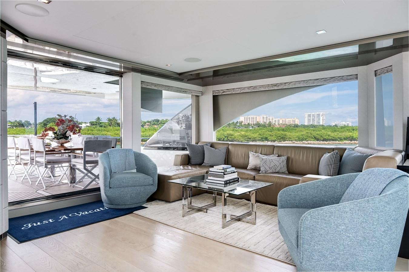 a living room with a large window aboard JUST A VACATION Yacht for Sale