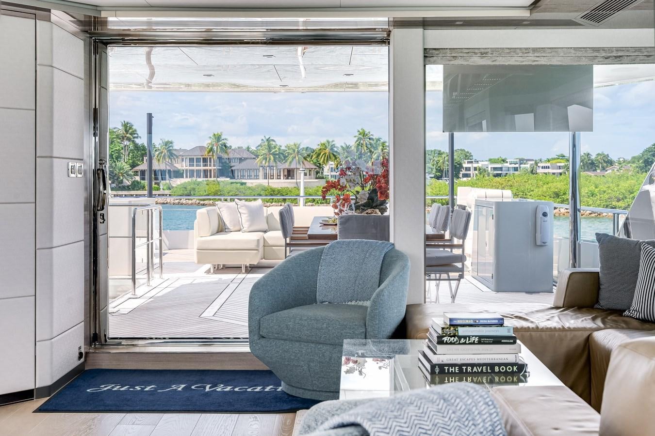 a living room with a patio aboard JUST A VACATION Yacht for Sale
