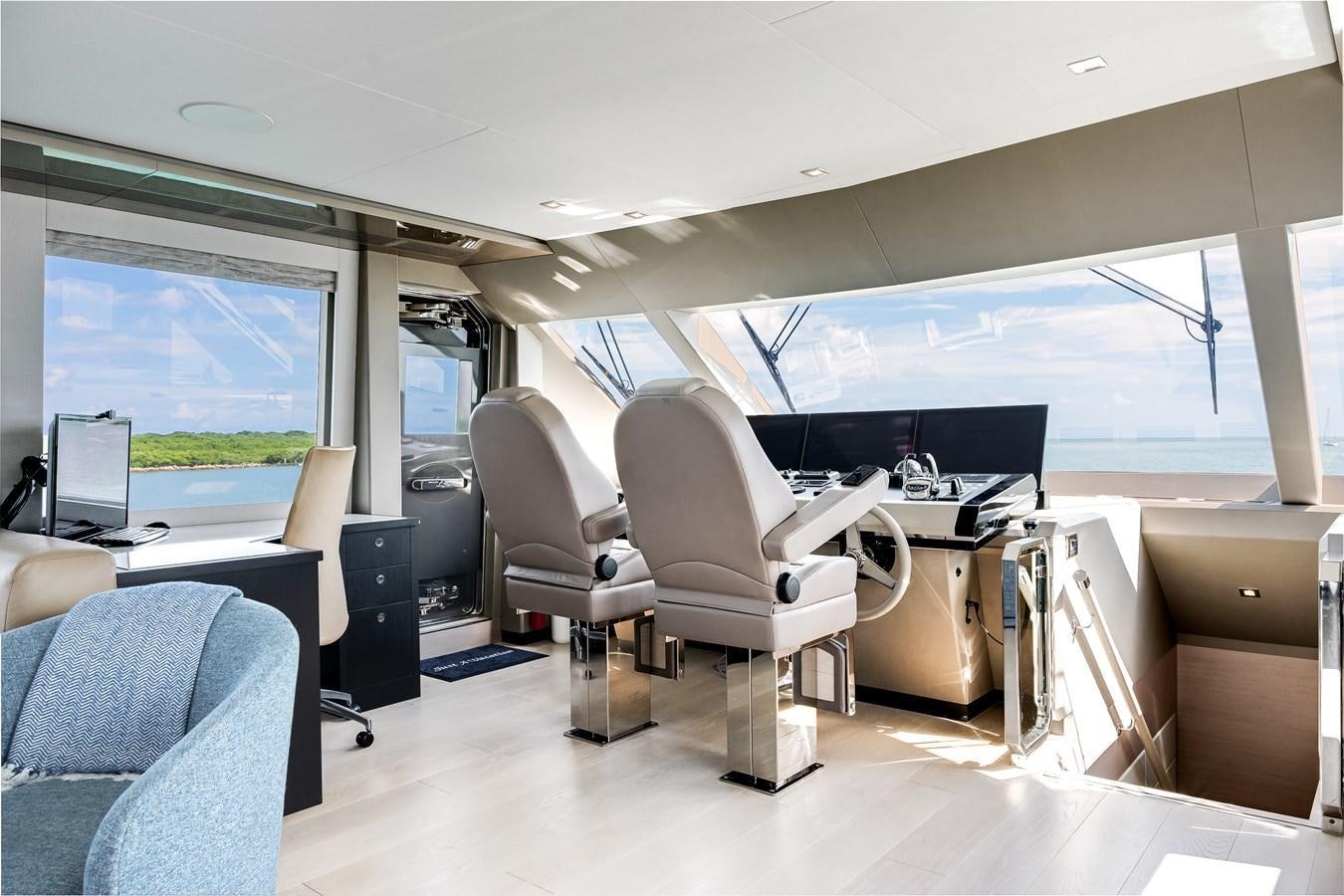 an empty office with a large screen aboard JUST A VACATION Yacht for Sale