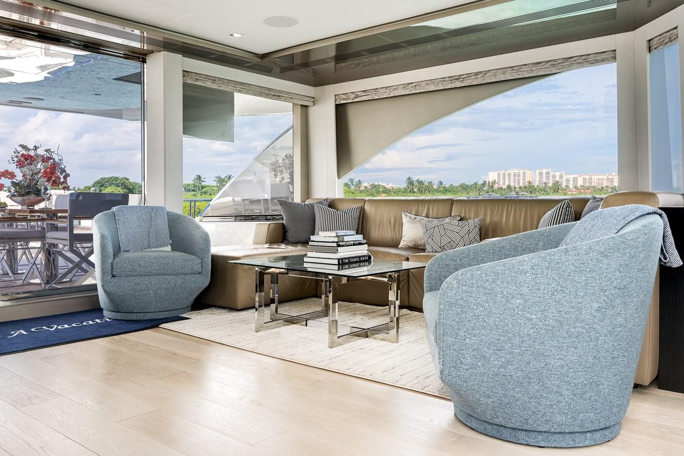 a living room with a large window aboard JUST A VACATION Yacht for Sale