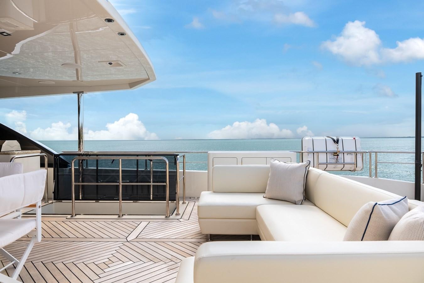 a lounge area with a large umbrella aboard JUST A VACATION Yacht for Sale