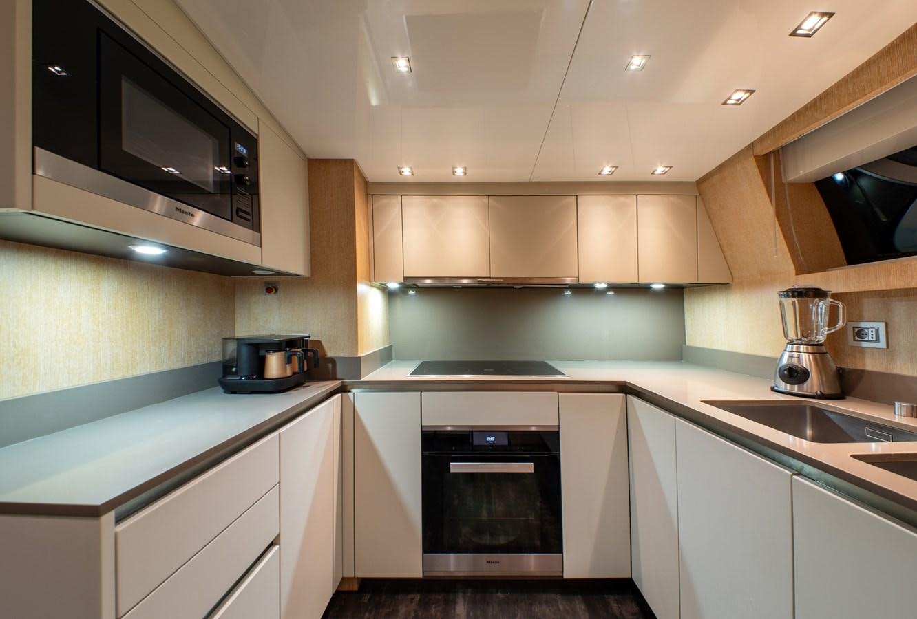 a kitchen with white cabinets aboard CYBELE Yacht for Sale
