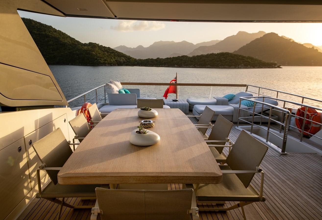 a deck with a table and chairs on it aboard CYBELE Yacht for Sale