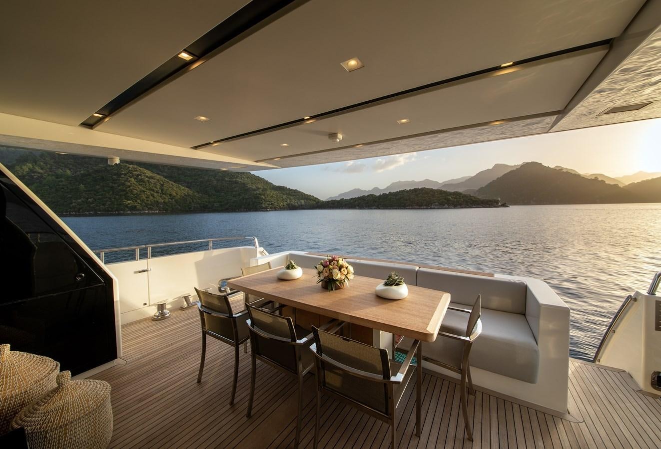 a table on a deck overlooking a body of water aboard CYBELE Yacht for Sale